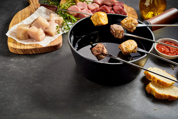 Various types of meat and fondue setting