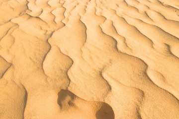 closeup of sand pattern of a beach in the summer.