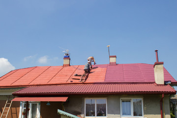 Man paints roof