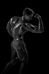 Strong Athletic Man Fitness Model posing back muscles, triceps o