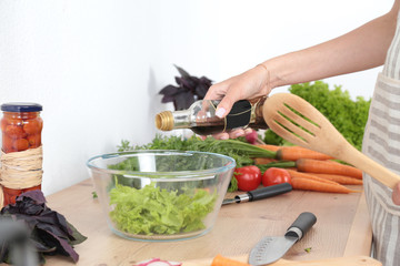 Fresh vegetables on the cutting board, salad in a glass dish. Concept of cooking