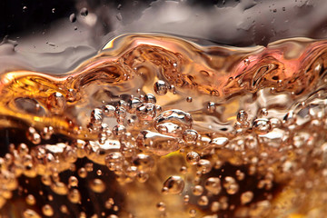 Abstract splashes of white wine on a black background