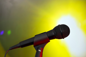 Stage microphone on brigh projector background
