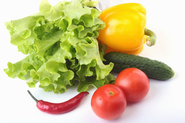 Assorted vegetables, fresh bell pepper, tomato, chilli pepper, cucumber and lettuce isolated on white background. Selective focus.