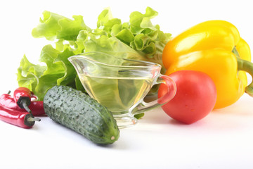 Assorted vegetables, fresh bell pepper, tomato, chilli pepper, cucumber, olive oil and lettuce isolated on white background. Selective focus.