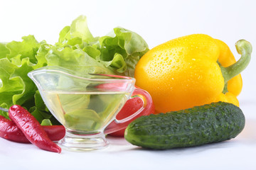 Assorted vegetables, fresh bell pepper, tomato, chilli pepper, cucumber, olive oil and lettuce isolated on white background. Selective focus.
