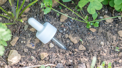 Pipette in the earth (ground)