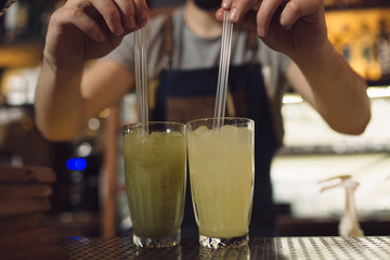 Fototapeta na wymiar Young male bartender preparing an alcohol cocktail