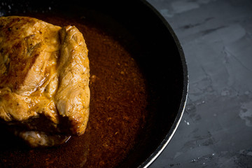 Roasted pork in the pan. Shallow depth of field.