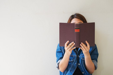 Closeup woman hand holding a book to read