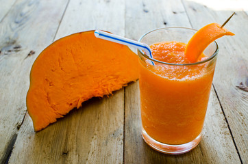 Healthy pumpkin smoothie. Healthy blended juice on rustic wooden table. Shot on daylight