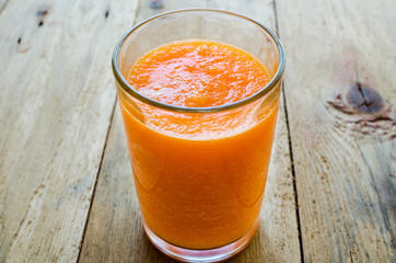 Pumpkin Smoothie. Healthy blended juice on rustic wooden table. Shot on daylight