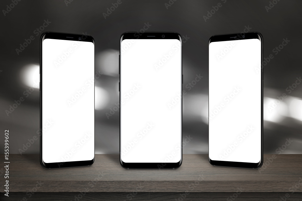 Poster Three mobile phones with isolated screen for mockup on the table. Bokeh lights in background.