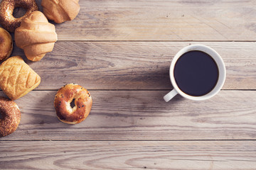Pastry with coffee on wooden table