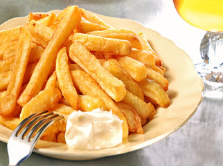 French fries, mayo and glass of beer. 