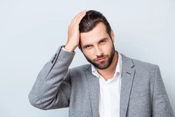 Photo sur Plexiglas Salon de coiffure Close up portrait of handsome young confident man in gray suit touching his perfect hair