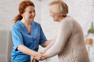 Beautiful charming doctor talking to her patient