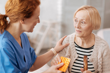 Sweet mature woman receiving prescribed pills