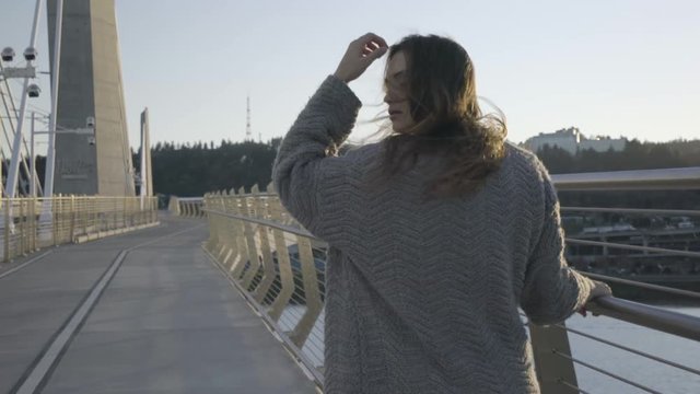 Emotional Young Woman Walks Alone On Bridge