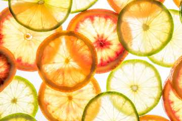 Bright lime and orange slices on white