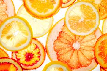 Beautiful fresh sliced mixed citrus fruits as background