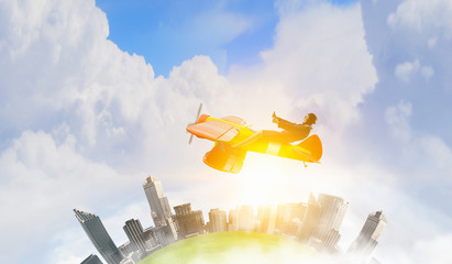 Woman in retro airplane . Mixed media