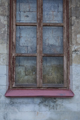 Obraz na płótnie Canvas Window in the wall walled up with stones