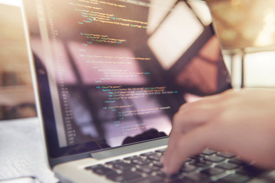 Closeup coding on screen, Woman hands coding html and programming on screen laptop, development web, developer.
