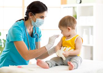 Doctor holds an injection vaccination the child - 155422824