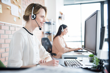 Cheerful smiling worker in earphones