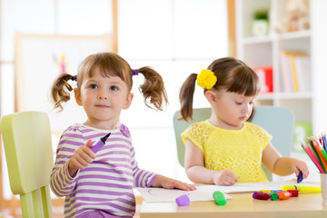 Kids drawing in kindergaten. Children paint in nursery. Preschooler with pen at home. Creative toddler.