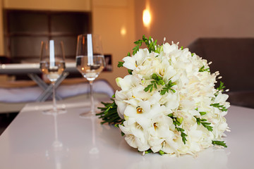 White wedding bouquet and glasses of wine