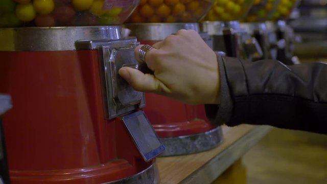 Closeup Of Teen's Hand As She Pays For A Gumball