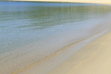 Soft sea wave on sandy beach, Beautifu colorful Greek beach with fine sand, Photo of sandy beach with soft wave in motion