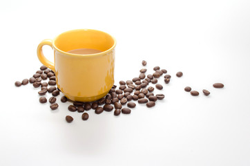 coffee beans and  yellow coffee cup isolated on white background