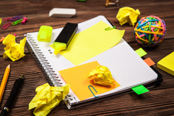 Open notepad with office supplies