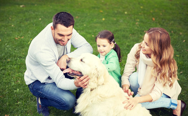 happy family with labrador retriever dog in park