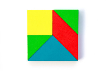 Wooden colorful toy block in multiple shape build to square design on white background