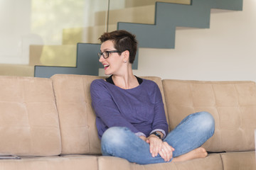 Obraz premium portrait of a young beautiful woman sitting on the sofa