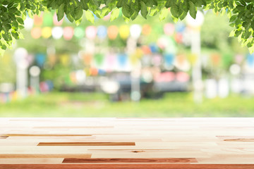 Empty wooden table with party in garden background blurred.