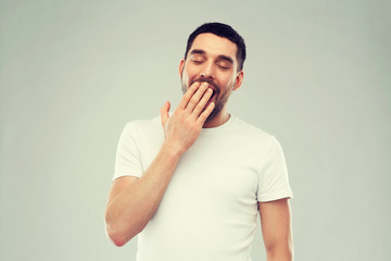 yawning man over gray background