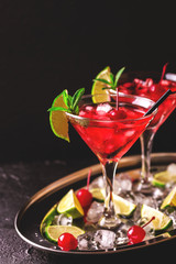 Strawberry daiquiri cocktail with lime, strawberry, cherry and mint