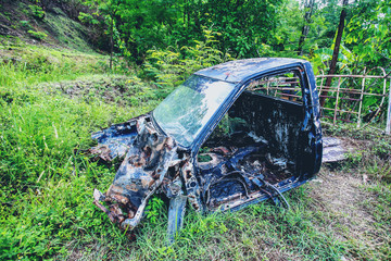 Old car wreck in the woods, vintage car wreck