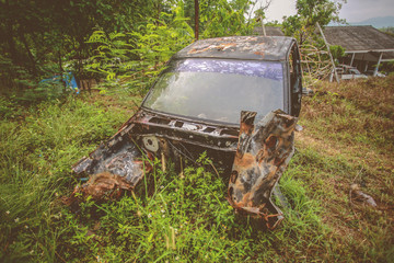 Old car wreck in the woods, vintage car wreck