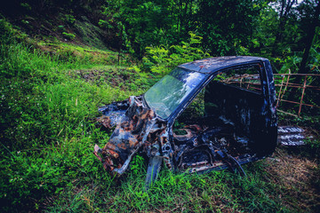 Old car wreck in the woods, vintage car wreck