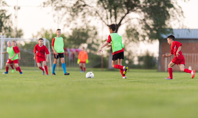 Obraz premium Kids soccer football - children players match on soccer field