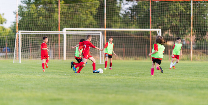 Kids soccer football - children players match on soccer field