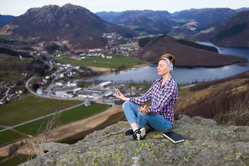 Naklejka premium A woman have a relax on the top of mountain