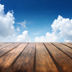 Naklejka na ściany i meble Summer sky with wooden table