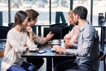 business team on meeting discussing project with laptop in cafe, business lunch concept